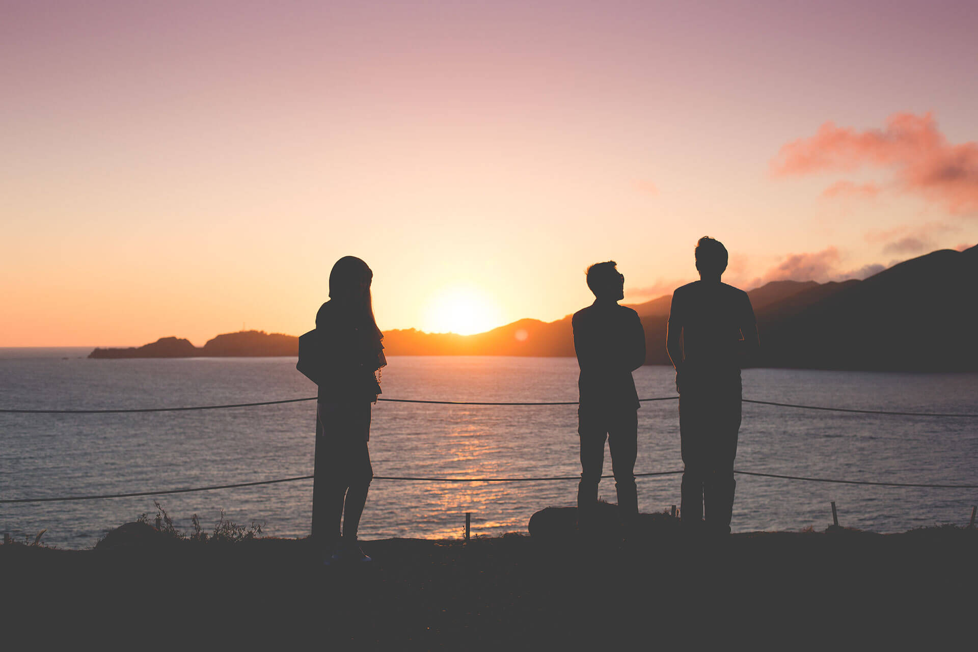 People Enjoying Sunset Over the Ocean